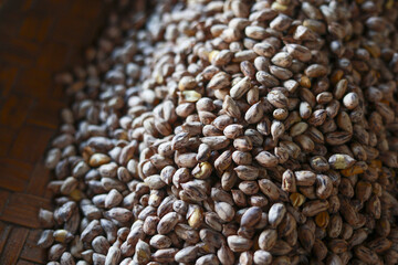 Obraz premium Macro close up view of pile of raw organic cocoa beans. natural texture and brown pattern on seeds create warm, rustic feeling of abundance and nature