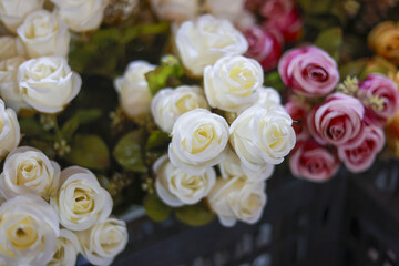 Close up of beautiful bouquet with artificial white and pink rose flowers. elegant floral arrangement evokes sense of everlasting romance and pure love for decoration