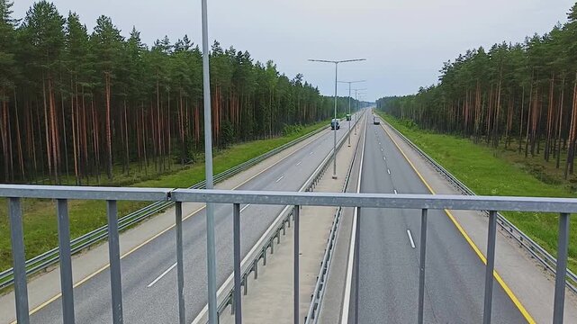 Russia. The M11 highway with cars moving along it. Aerial view from the overpass