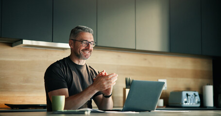 Mature man, applause and laptop at house with good news, financial freedom and lotto winner. Smile, male person and clapping hands with pc for giveaway announcement, finance success and loan approval