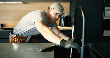 Maintenance, repair and tap with plumber in kitchen of home for installing or testing water supply....