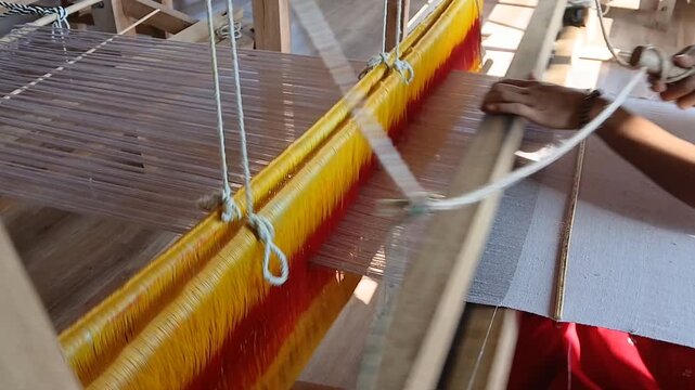 Handloom weaver in India working in her loom.