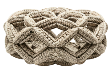 Beige crocheted pouf with a chunky diamond waffle pattern isolated on transparent background