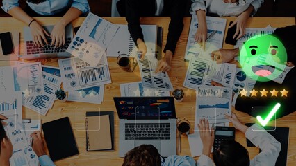 A diverse group of professionals collaborates in an office setting, analyzing data and reports to develop strategies for business improvement and growth. Raster