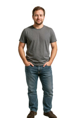 Man standing with hands in pockets indoors wearing a gray t-shirt and blue jeans in a casual pose during daylight hours