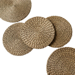 Five round woven water hyacinth placemats arranged artistically on a transparent background