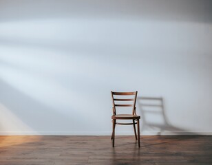 A solitary, vintage wooden chair cast a shadow against the pristine background, evoking a sense of calm and simplicity.