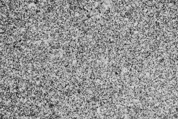 A tightly cropped, high-density speckled texture composed of tiny black, white, and gray flecks, suggesting a close-up of granite, salt and pepper stone, or a monochromatic composite material.