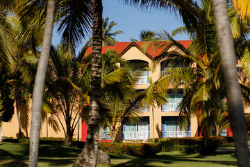 A beautiful seaside resort with palm trees, colorful buildings, and artistic statues on a sunny summer day. Vacation season in the Caribbean. Hotel in Punta Cana, Dominican Republic, July 22, 2025