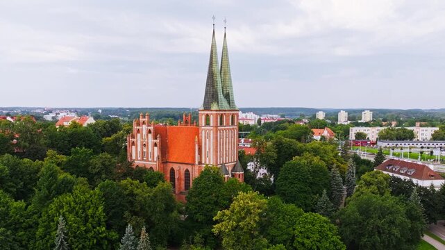 Drone footage showing historic Olsztyn church architecture and tall spires