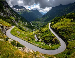 Winding mountain road nestled amidst lush green valleys