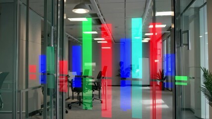 Modern office interior with glass walls, digital data visualization, colorful bar charts, and bright lighting create dynamic, productive workspace