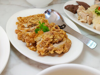 Delicious crispy slice deep-fried chicken in a white dish at the restaurant.