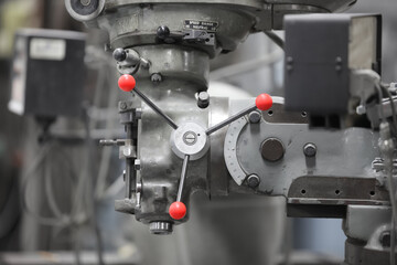 Close up view of old Milling machine head in a machine shop.