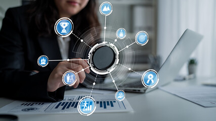 A business professional uses a digital interface to analyze data trends in a modern office setting, showcasing growth and strategic planning through innovative technology. Crux