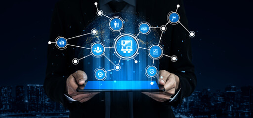 A businessman holds a digital tablet showcasing a global network of connections with various icons, symbolizing technology and modern business communication. Tessel
