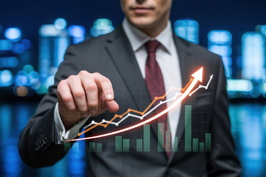 Business growth concept businessman pointing at financial chart showing increasing trend in stock market profit - Powered by Adobe