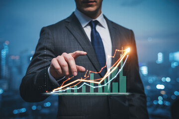 Business growth concept man pointing at financial chart showing increasing trend in stock market profit night