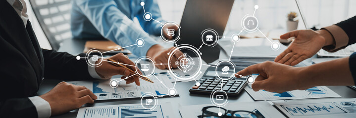 Engaging business meeting in a modern office space featuring hands-on collaboration with digital marketing tools, emphasizing data analysis and strategic planning for success. Amity