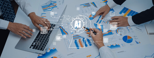 Business professionals collaborate on data analysis and chart discussions with advanced technology, highlighting teamwork and strategy in a modern office environment. Trope