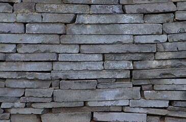 Background, texture wall made of natural stone close gray