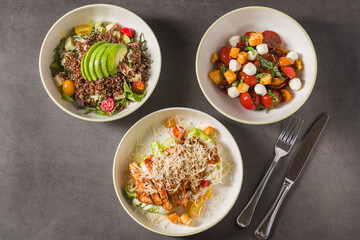 Trio of healthy bowls featuring grains, vegetables, avocado and cheese