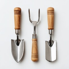 Gardening tools including a trowel and cultivator on white background.