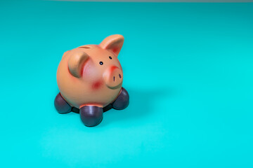 A piggy bank, a symbol of savings, set against a solid backdrop, evokes financial security amid economic downturns.