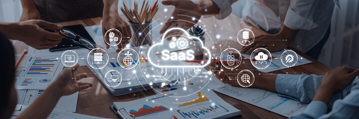 A dynamic business team works on innovative SaaS solutions, analyzing data and collaborating with digital icons in a modern office setting, emphasizing teamwork and technology. Trope