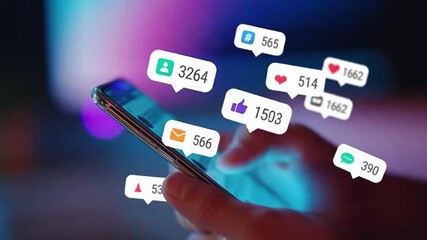 A person is holding a smartphone with social media icons, such as likes and comments, floating around it. The image represents online engagement and social media activity. - Powered by Adobe