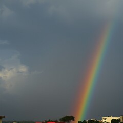 Rainbow Over Silhouettes &ndash; Atmospheric Light Spectrum in Urban Storm Scene