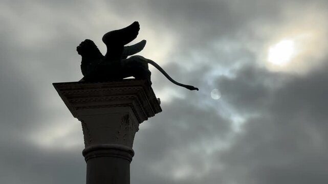 The Lion of Venice winged lion against moody sky in the Piazzetta di San Marco, Italy