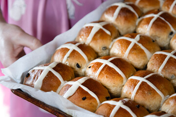 Close-Up of Freshly Baked Hot Cross Buns on Parchment-Lined Tray