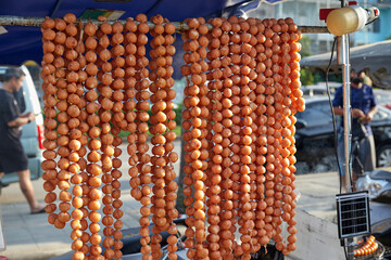 I-san pork meat sausage hanging for sale at street market in Thailand