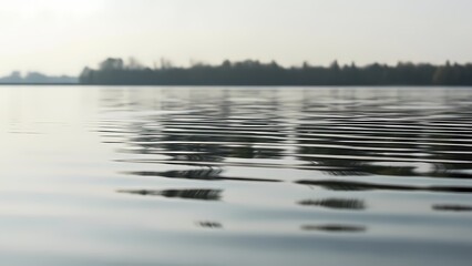 A peaceful minimal scene of calm water with subtle ripples and reflections. Ideal for wellness, serenity, meditation, and nature backgrounds.