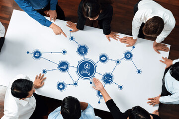 A diverse team of professionals collaborates in a modern office setting, analyzing data and solutions for effective customer relationship management strategies. Amity