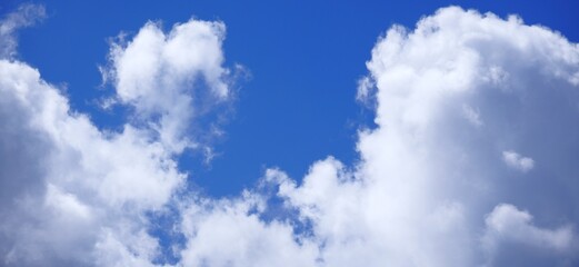 Fluffy White Cumulus Clouds Against a Vibrant Blue Sky.