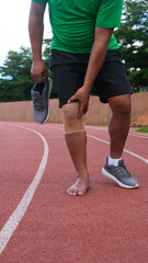 Fototapeta premium Young adult male with muscle pain during running. runner have knee ache due to Runners Knee or Patellofemoral Pain Syndrome