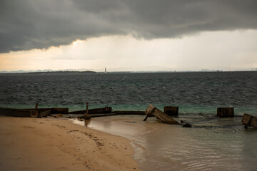 Dramatic Overcast Sunset Sky Over Moody Coastal Landscape and Seawall