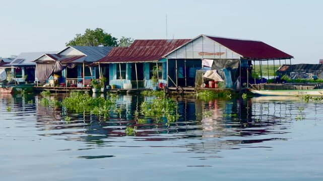 Traditional vibrant colourful mirror reflections of wooden floating house for the Khmer residents of Prek Toal floating village, Tonle Sap, Cambodia.