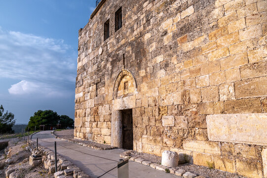 Preserved stone fortification with arched doorway in Zippori National Park, Galilee, Israel. Weathered limestone blocks glow in warm evening light along a quiet path