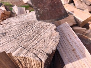 Chopped Firewood and Axe in Sunlight