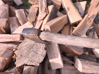 Chopped Firewood and Axe in Sunlight