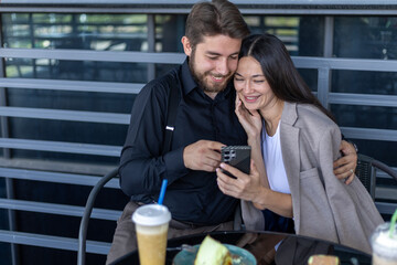 Business man and woman discussing work outside with takeaway drinks