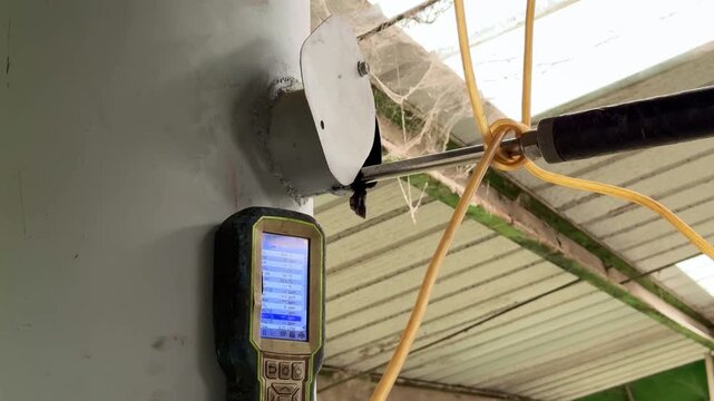 Air emission analyzer connected to a factory outlet, measuring pollutant levels for regulatory and environmental assessments.