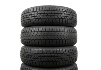 Stack of four pristine, matte black radial car tires, detailed tread patterns visible, set against a transparent studio background using low angle commercial lighting. Concept for automotive