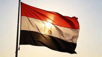 Vibrant Egyptian flag fluttering in the sunlight, ideal for patriotic themes, backgrounds, or cultural presentations.