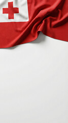 A close-up view of a red flag featuring a white square with a red cross, draped on a white surface.