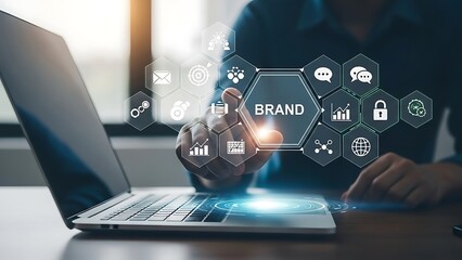 Business professional analyzing digital brand strategy on laptop with futuristic technology icons in modern office environment