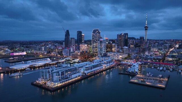 Dolly Flight through Auckland , New Zealand. Skyline. New Skyscrapers. Urban Canyon in Sunset or Sunrise Light. Aerial Pedestal in Establishing Night Drone Shot. Glowing street lights 